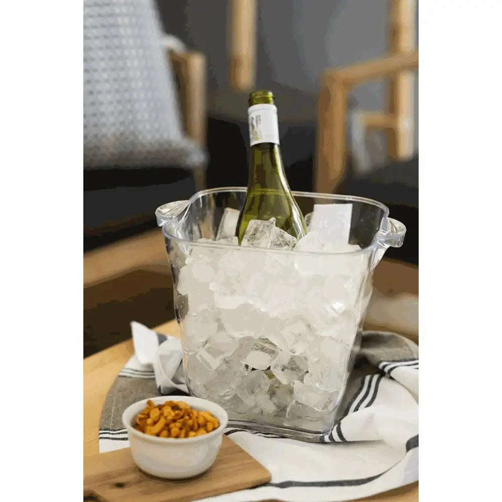 Glass wine cooler with a bottle of white wine on a wooden table.
