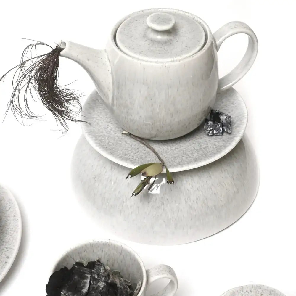 Grey ceramic teapot and cup set on a white background