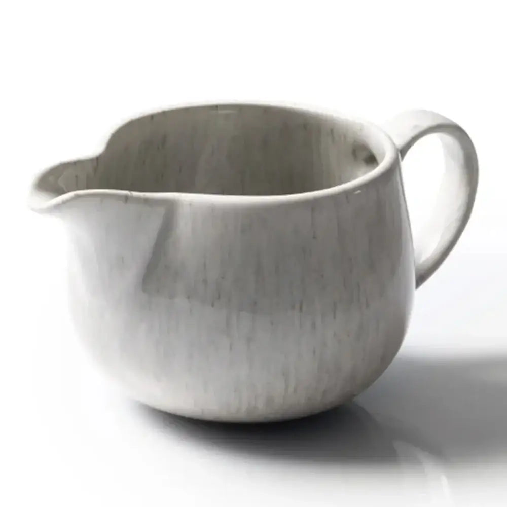 White ceramic pitcher on a white background