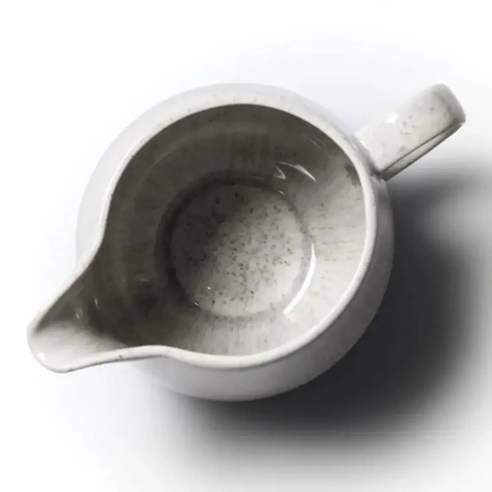 White ceramic pitcher on a white background