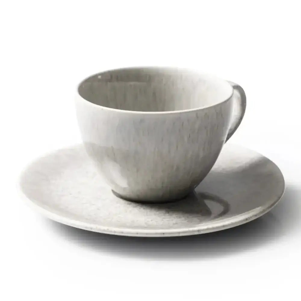 Grey marble cup and saucer on a white background