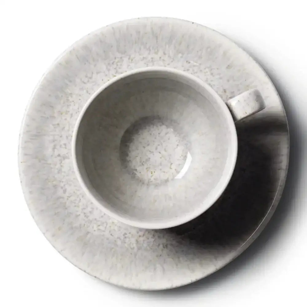 Grey ceramic cup and saucer set on a white background