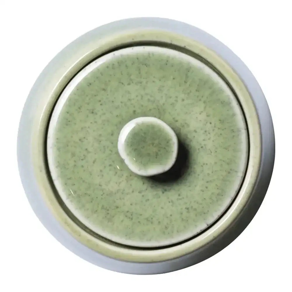 Round ceramic dish with a textured surface on a white background