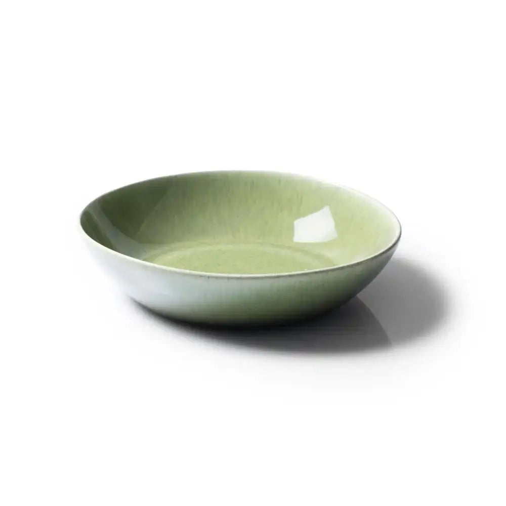 Green ceramic bowl on a white background