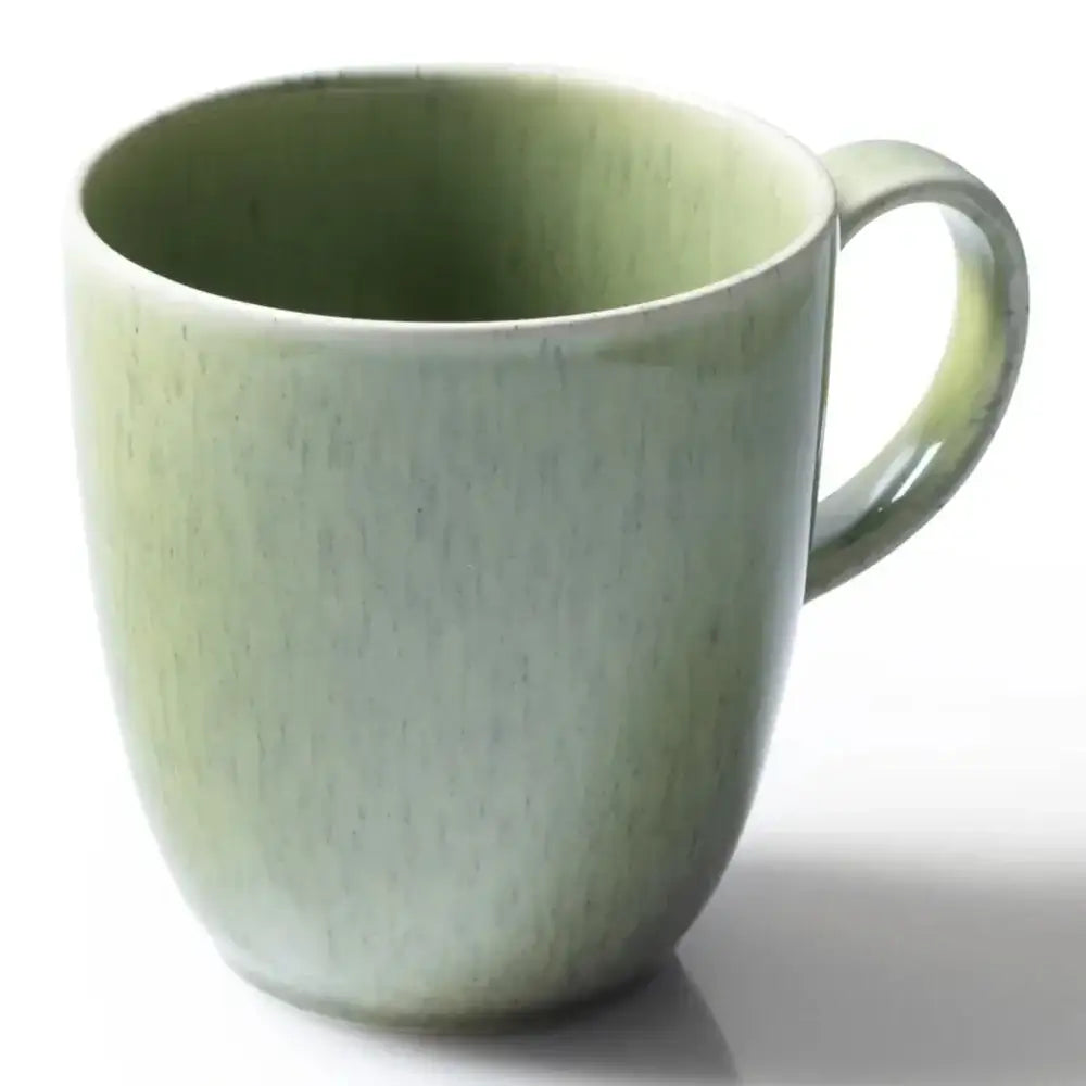 Green ceramic mug on a white background