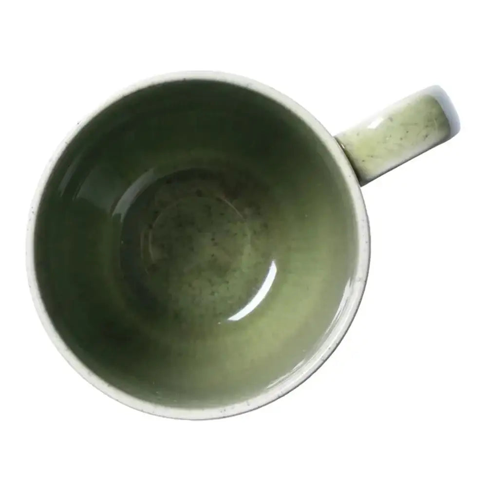 Green ceramic mug on a white background