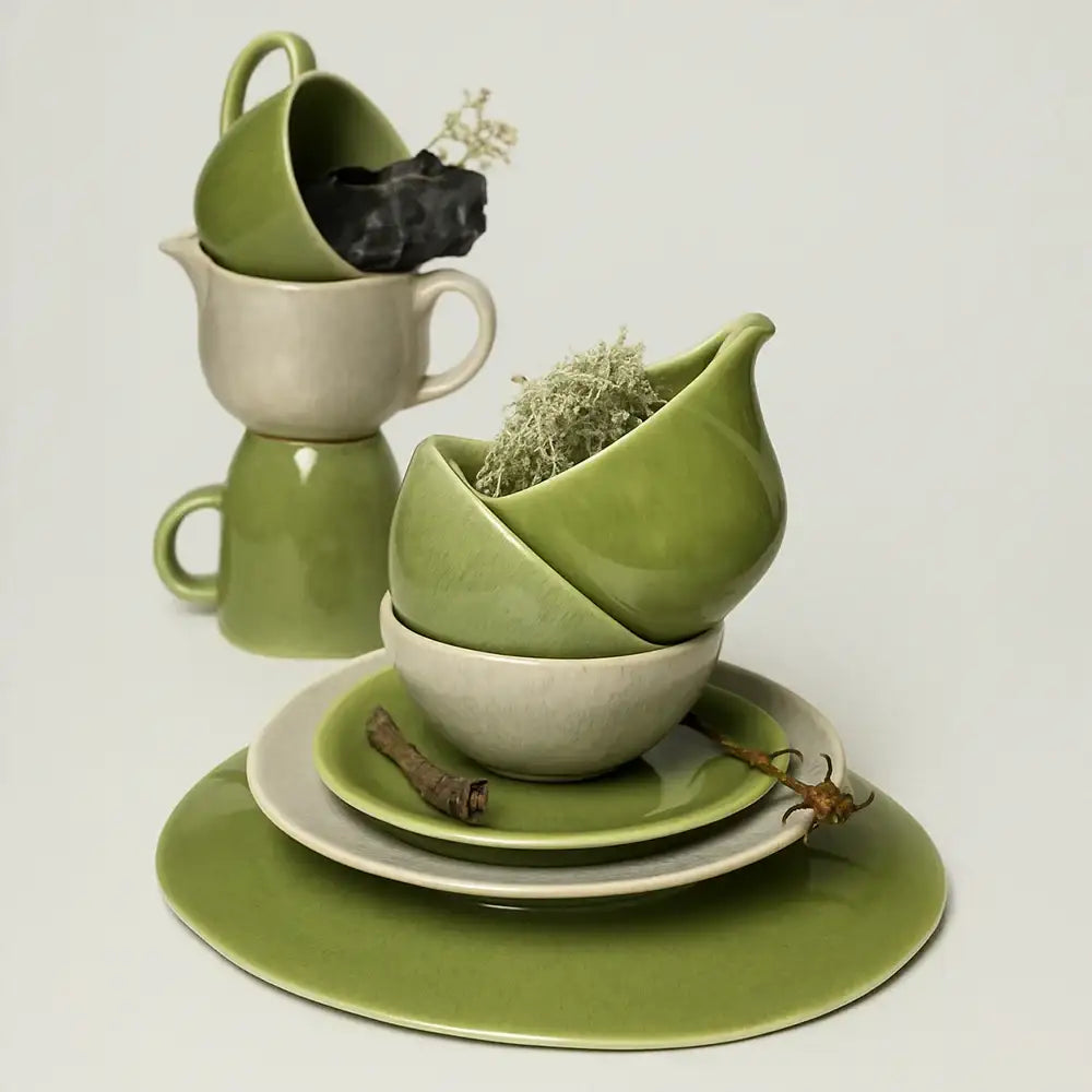 Green and white ceramic tableware set on a light gray background