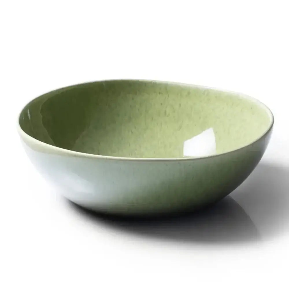 Green ceramic bowl on a white background