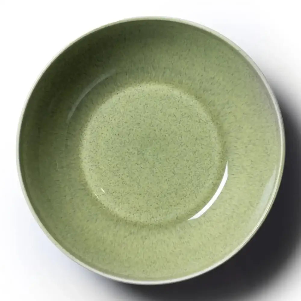 Green ceramic bowl on a white background
