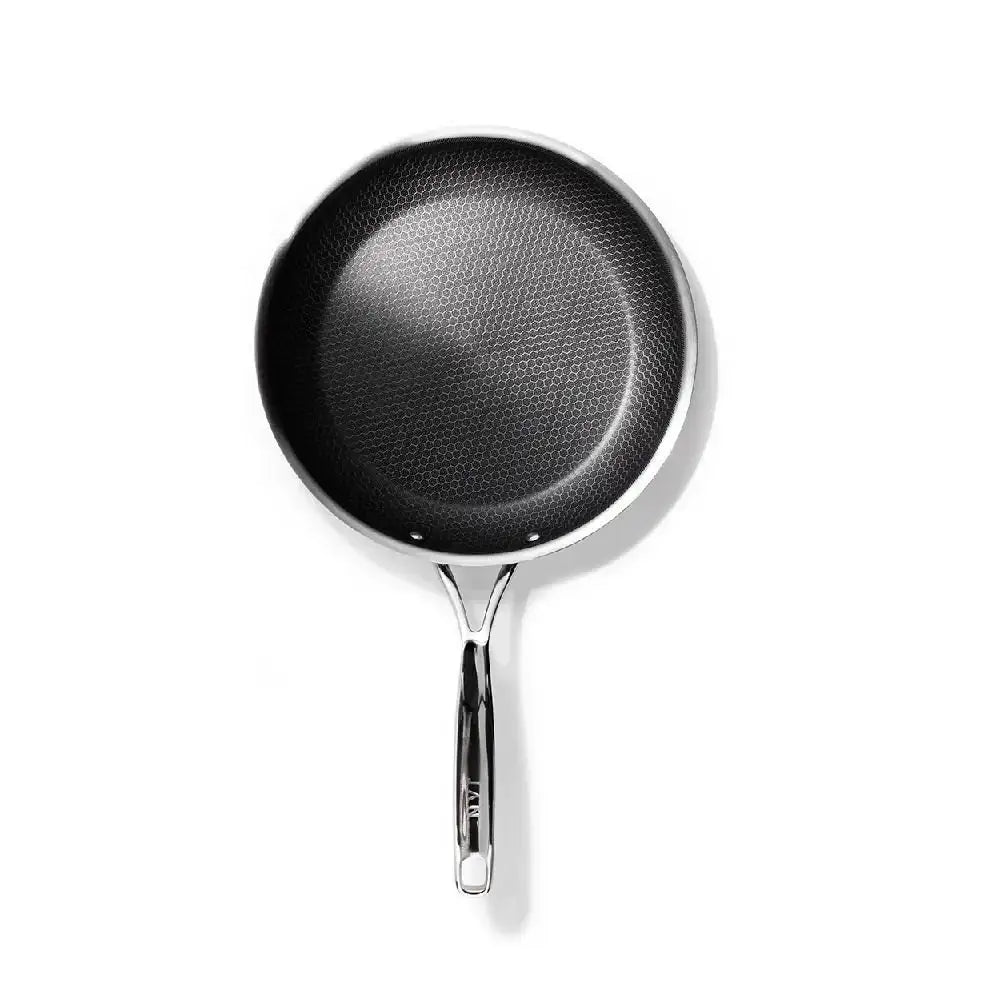 Black frying pan with a textured surface on a white background