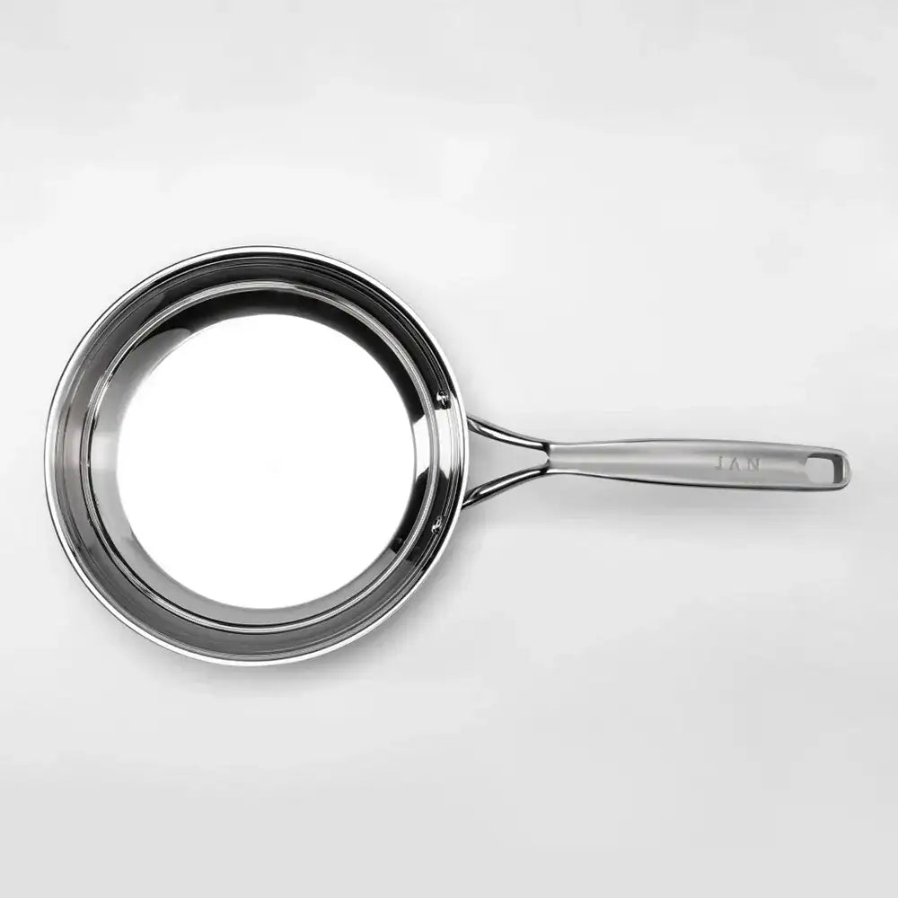 Stainless steel frying pan on a white background