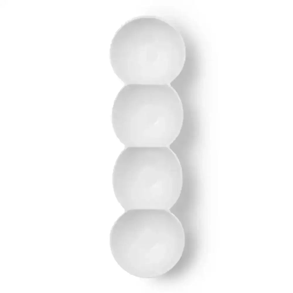Four white spherical objects stacked vertically on a white background
