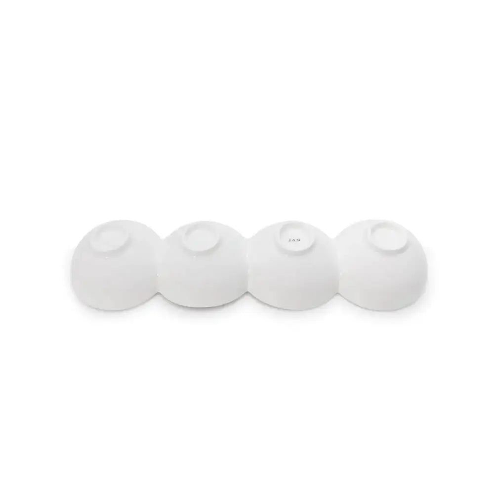 Four white spherical objects on a white background