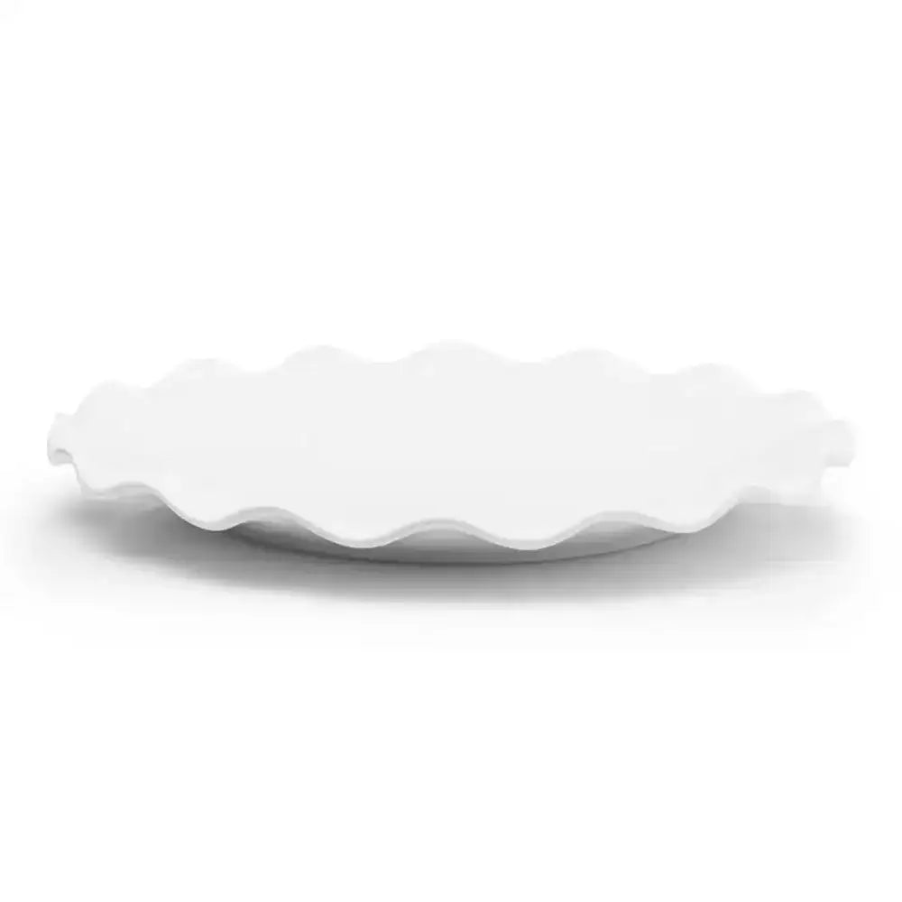 White ceramic plate with wavy edge on a white background