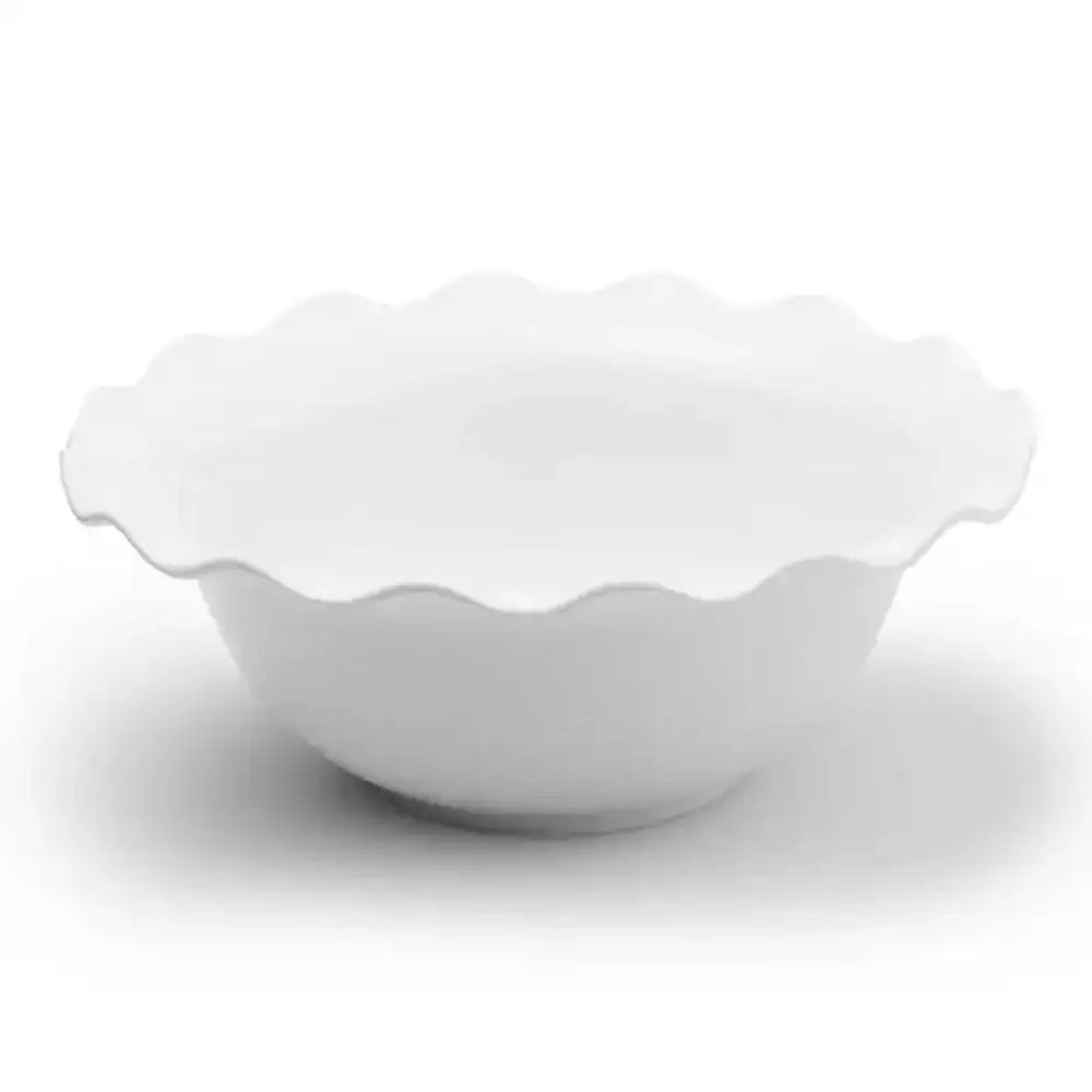 White ceramic salad bowl with scalloped edge on a white background