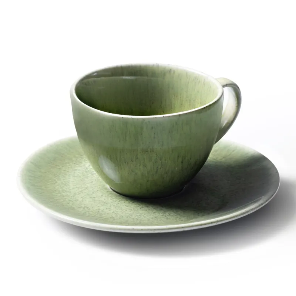 Green ceramic cup and saucer on a white background