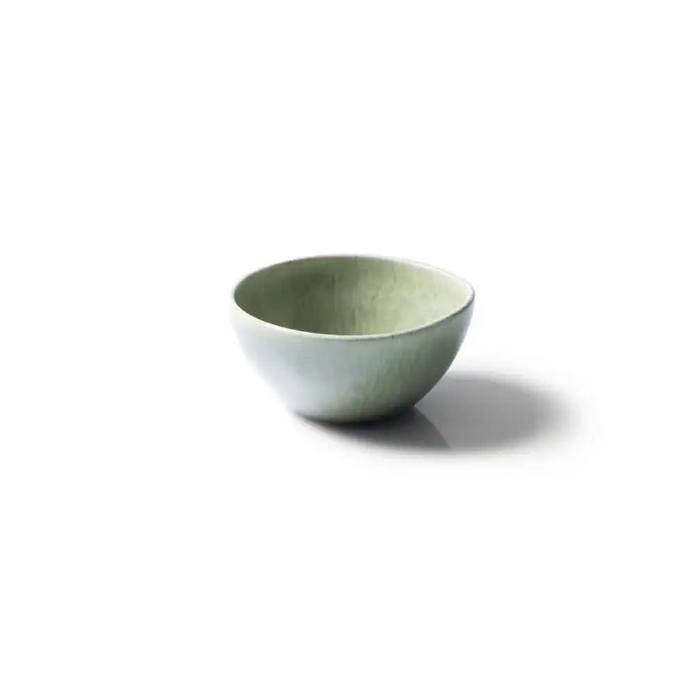 Green ceramic bowl on a white background