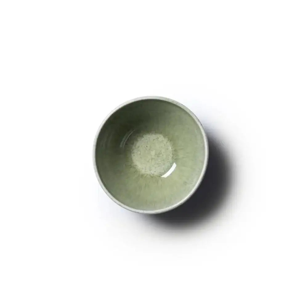 Green ceramic bowl on a white background