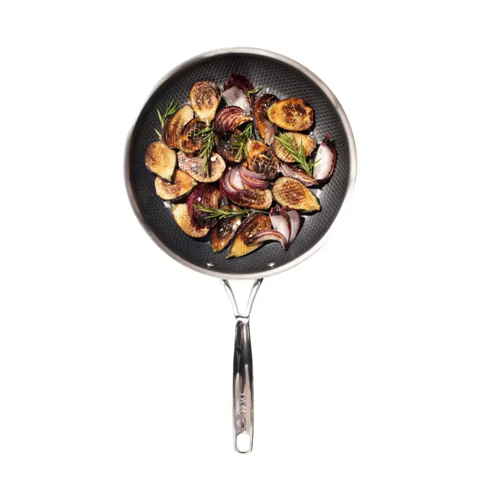 Frying pan with roasted vegetables on a white background