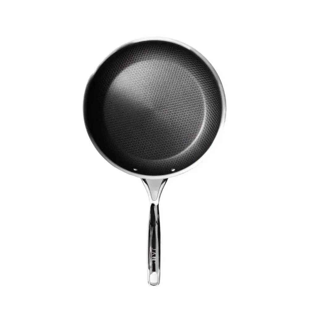 Black frying pan with a textured surface on a white background