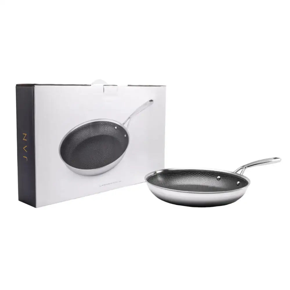 Black frying pan with handle next to its packaging on a white background