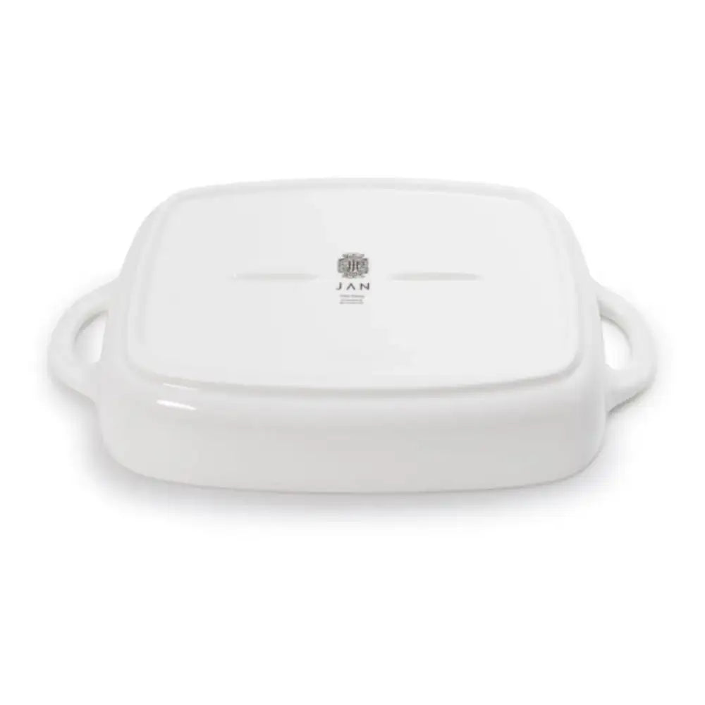 White ceramic baking dish with handles on a white background
