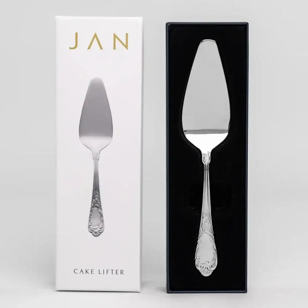 Silver cake lifter in packaging with 'JAN' branding on a gray background