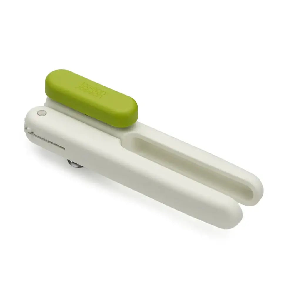 White kitchen tool with a green handle on a white background