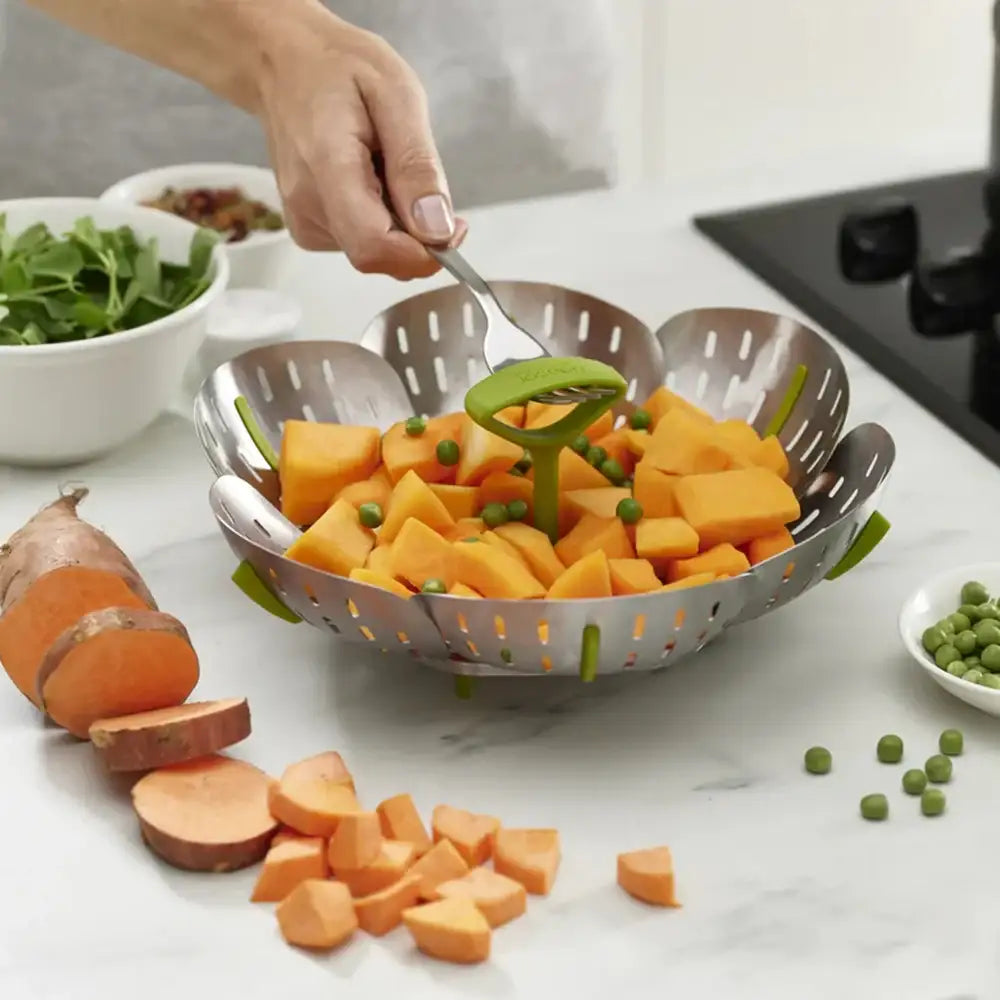 Person preparing sweet potatoes in a kitchen setting with a colander.