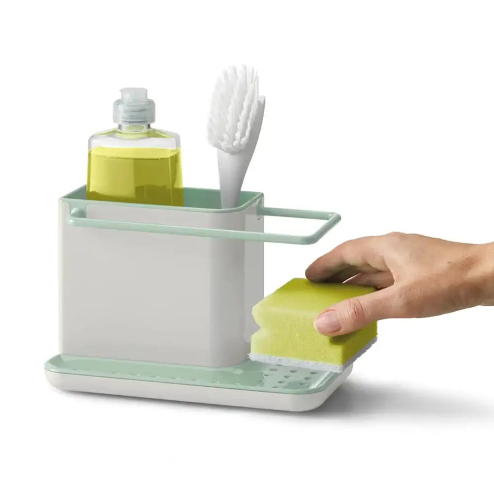 Dishwashing organizer with sponge, brush, and soap bottle on a white background