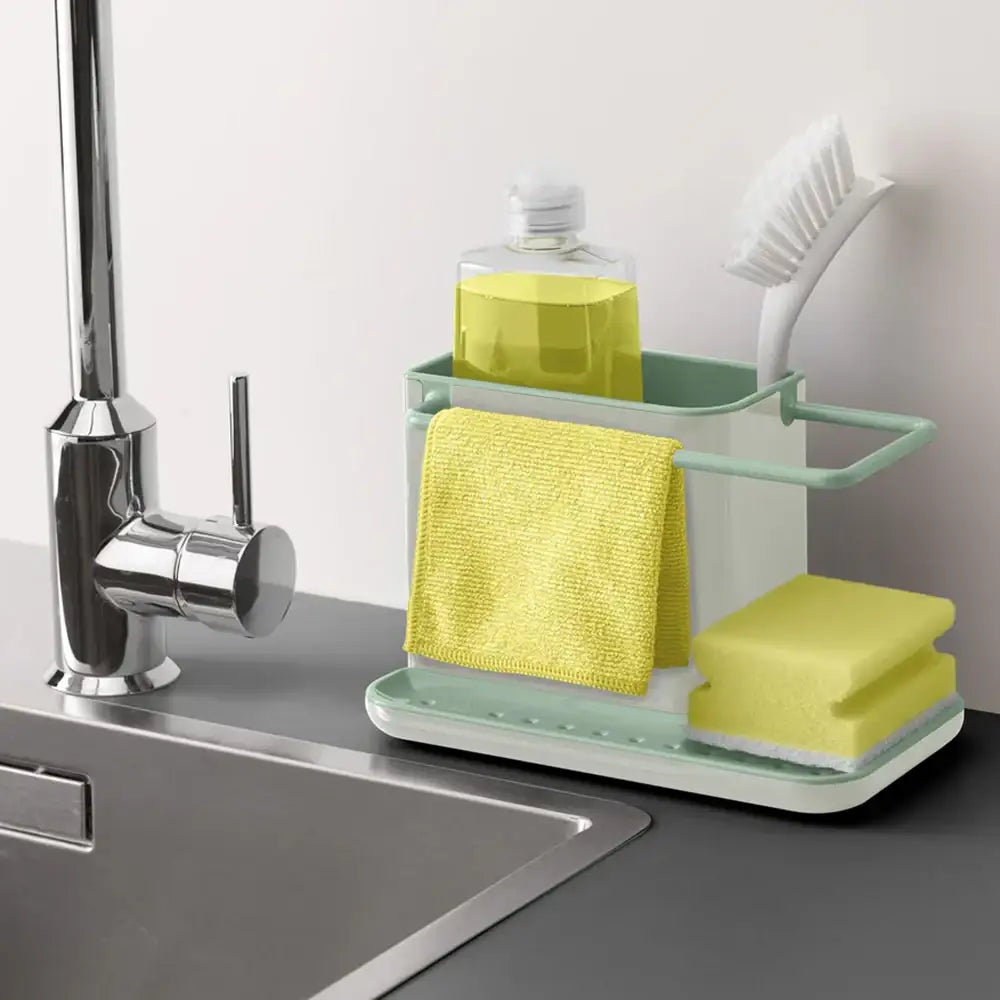 Kitchen sink caddy with sponge, scrubber, and soap holder on a kitchen counter.