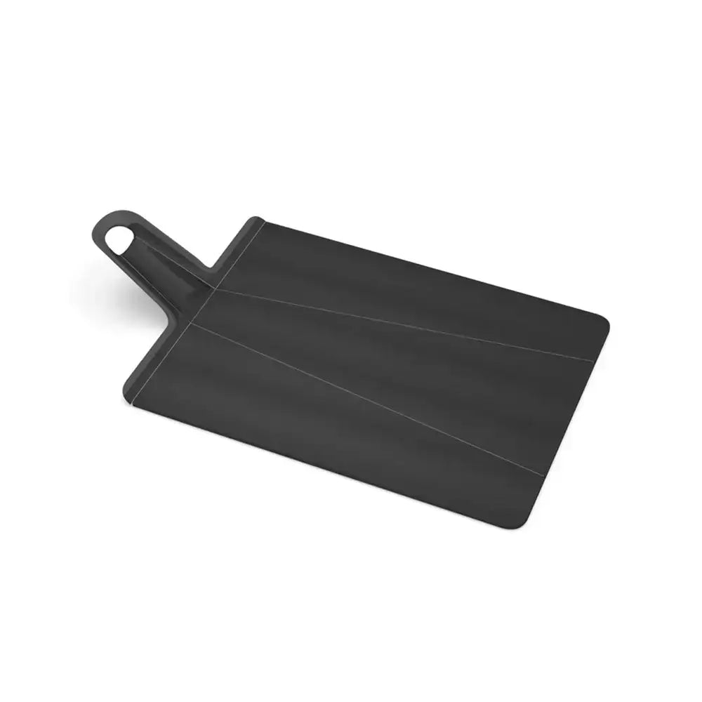 Black cutting board with handle on a white background