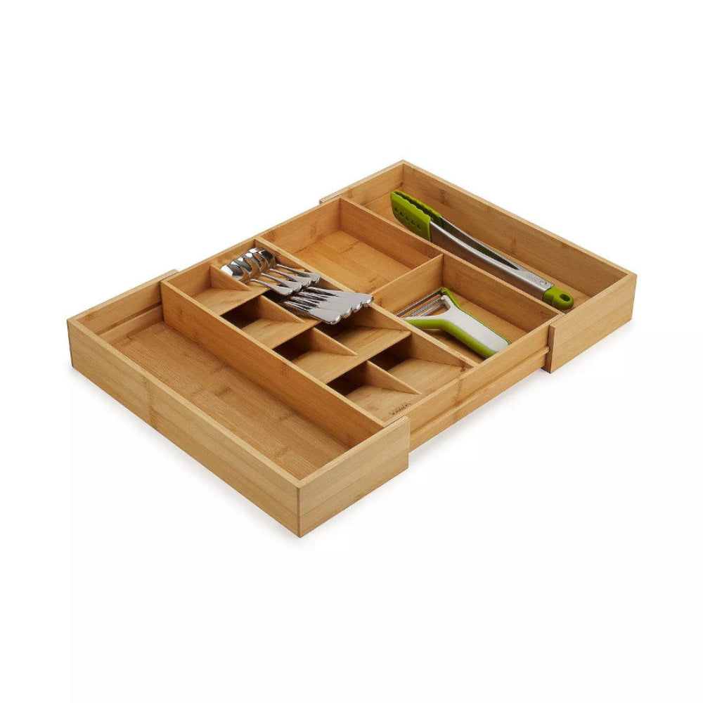 Wooden kitchen utensil organizer with cutlery on a white background