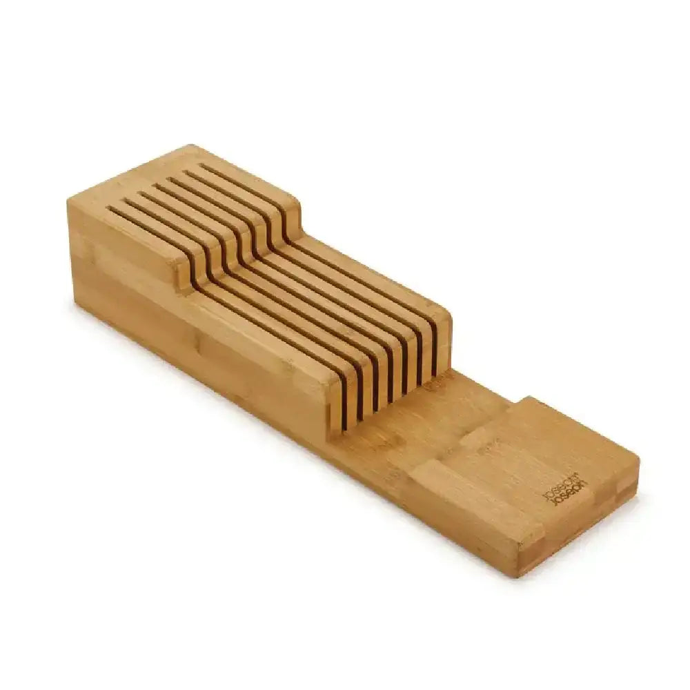 Wooden knife block with multiple slots on a white background