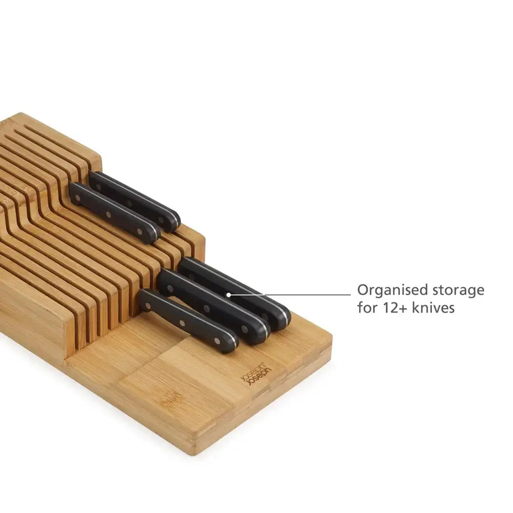 Wooden knife block with black knives on a white background