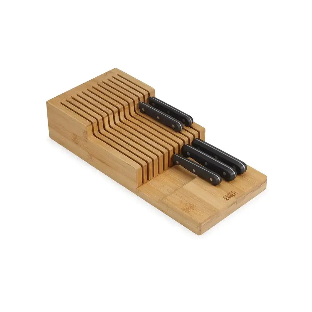 Set of knives in a wooden block on a white background