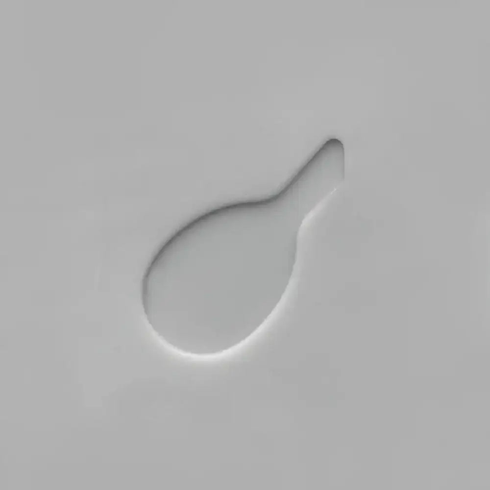 Closeup of a grey cutlery organizer slot shaped for utensils, minimalist design.