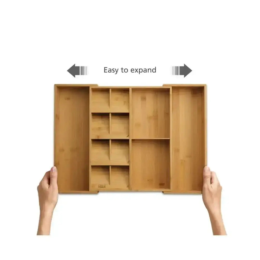 Wooden organizer with expandable compartments held by hands on a white background