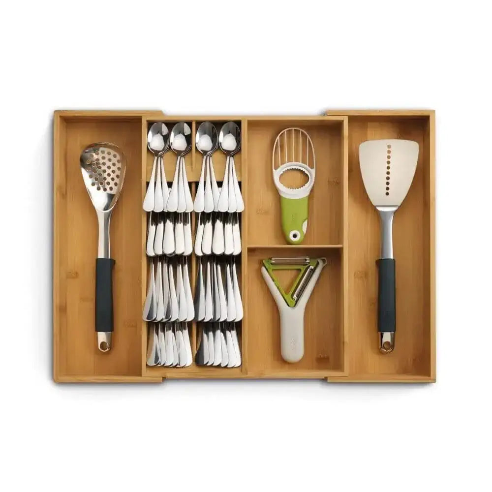 Wooden kitchen utensil organizer with spoons, ladles, and other tools on a white background