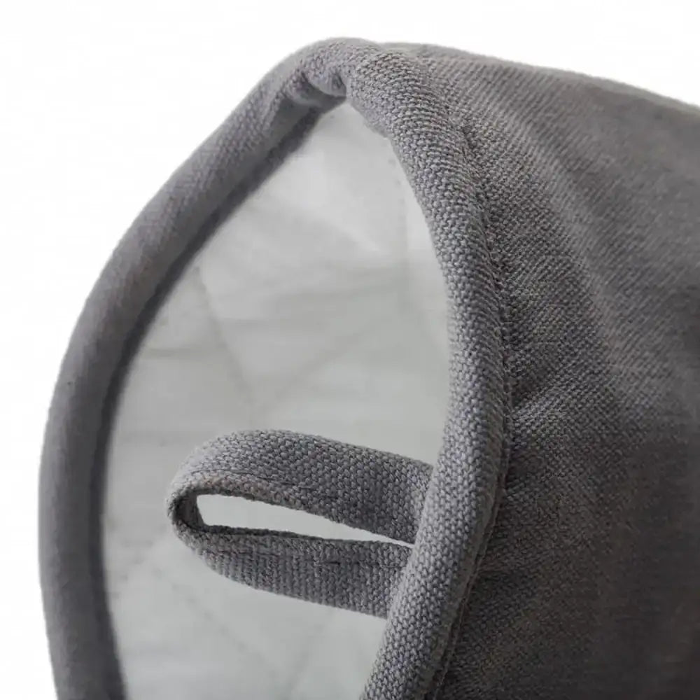 Close-up of a gray oven glove with a textured surface on a white background