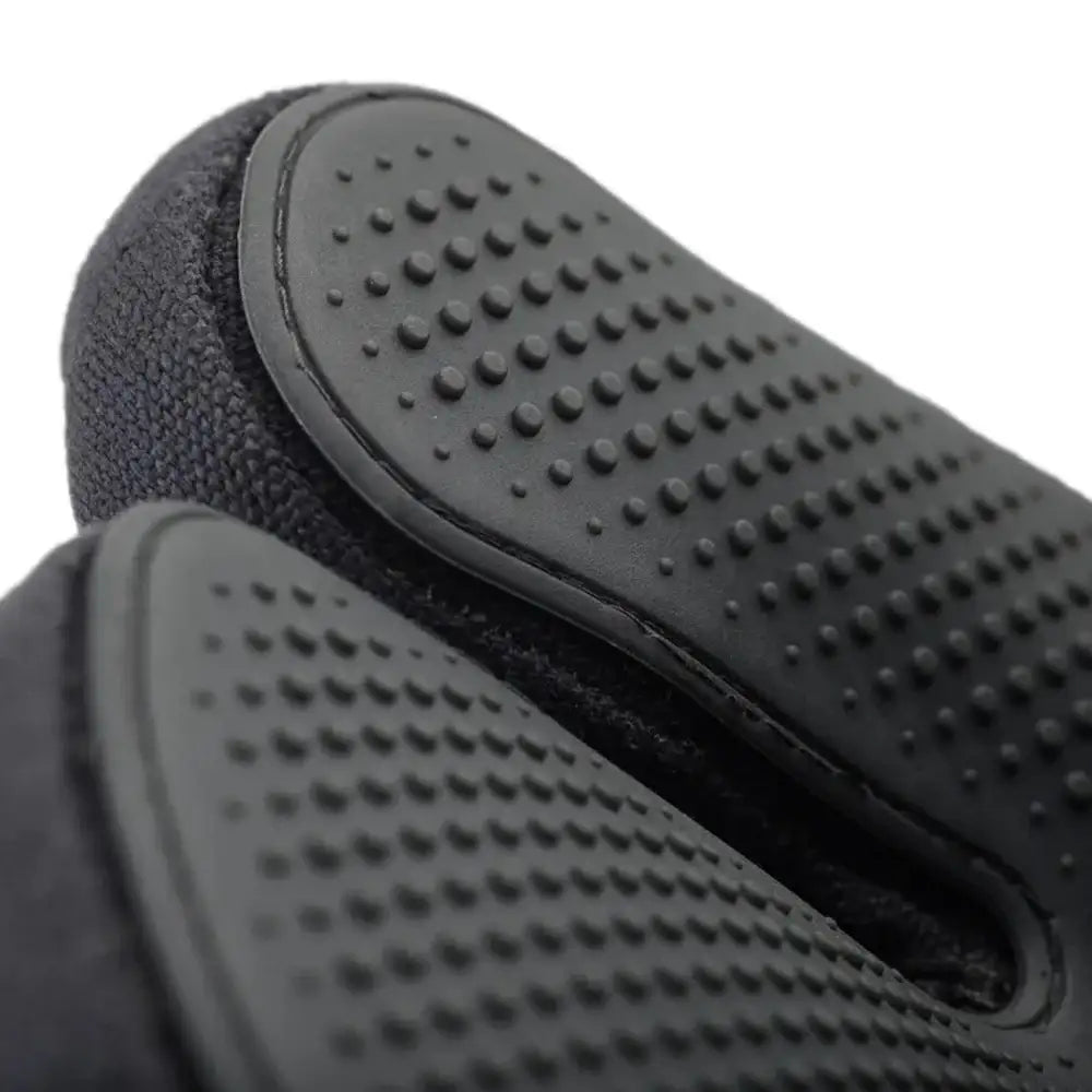 Close-up of black textured gloves on a white background