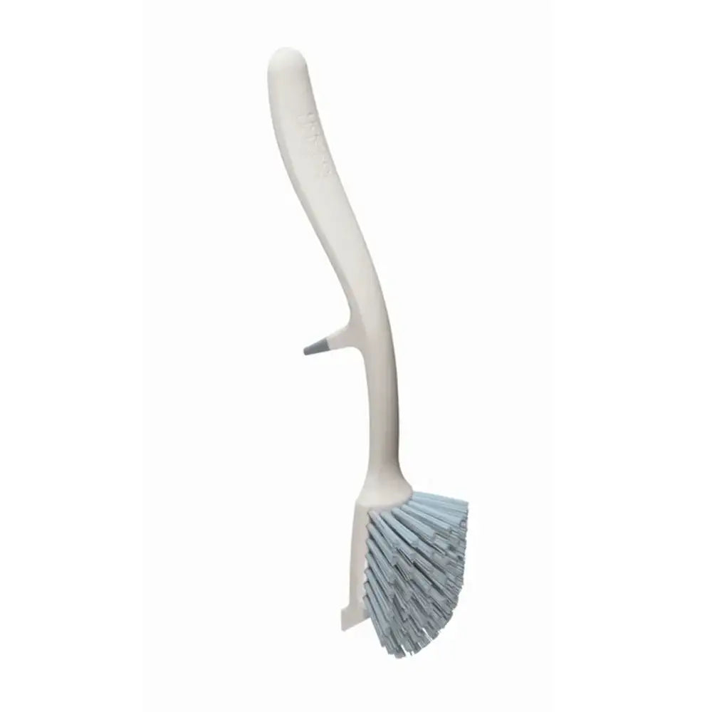 Cleaning brush with white handle and blue bristles on a white background
