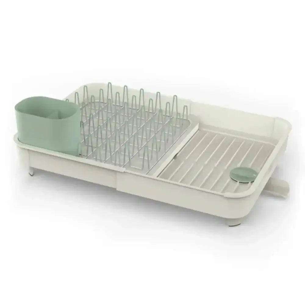 Dish drying rack with green dishes on a white background