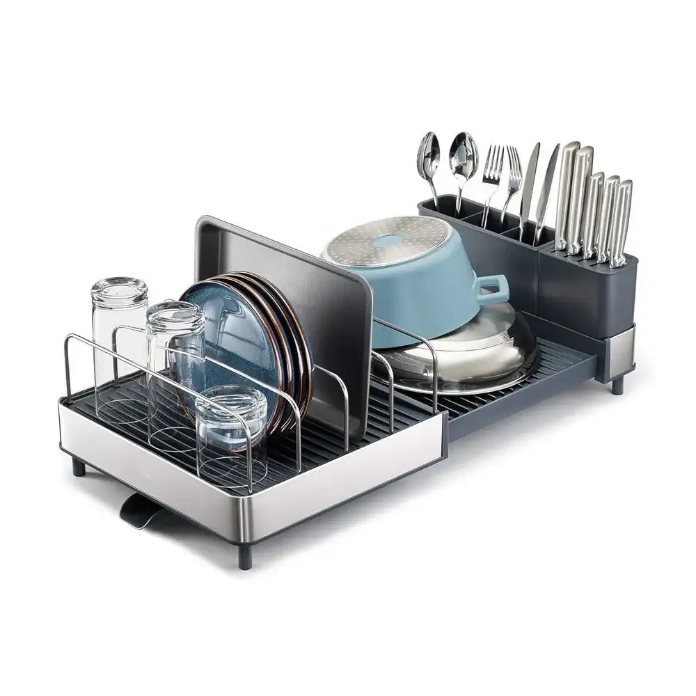 Dish drying rack with dishes and utensils on a white background