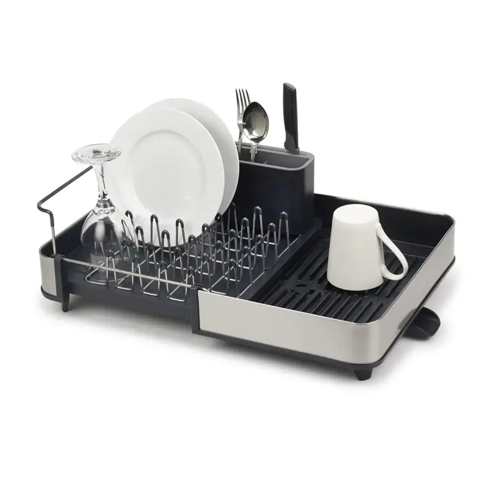 Dish drying rack with dishes on a white background