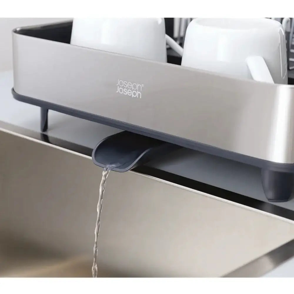 Joseph Joseph kitchen sink strainer with water flowing into a sink