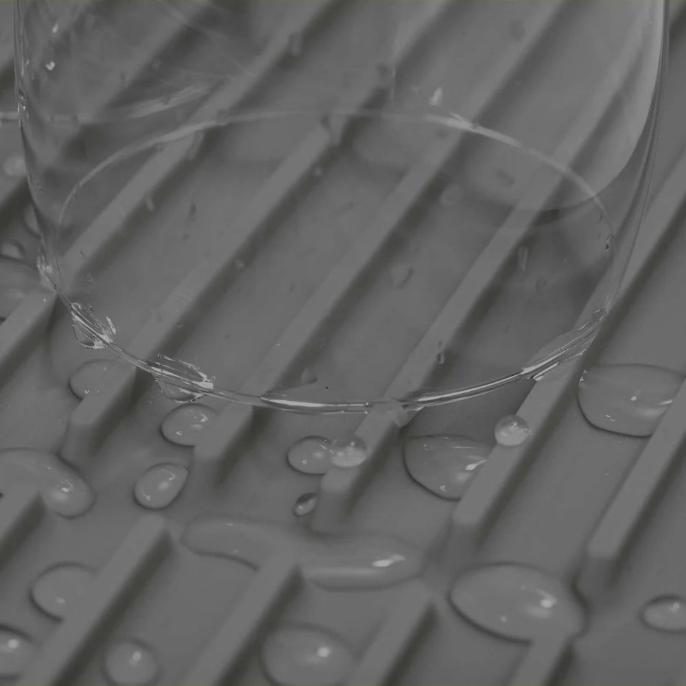 Clear glass on a textured gray surface with water droplets