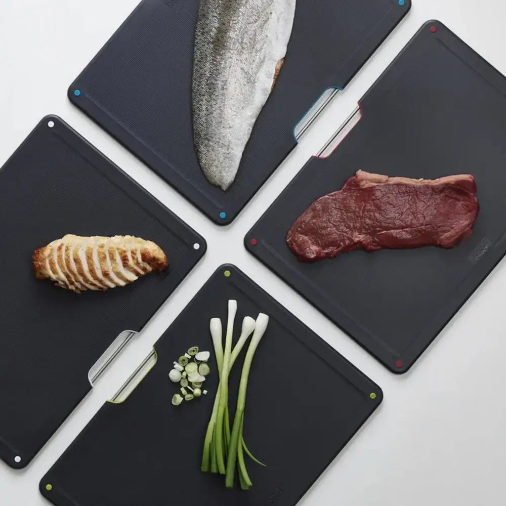 Black cutting boards with various food items on a white background