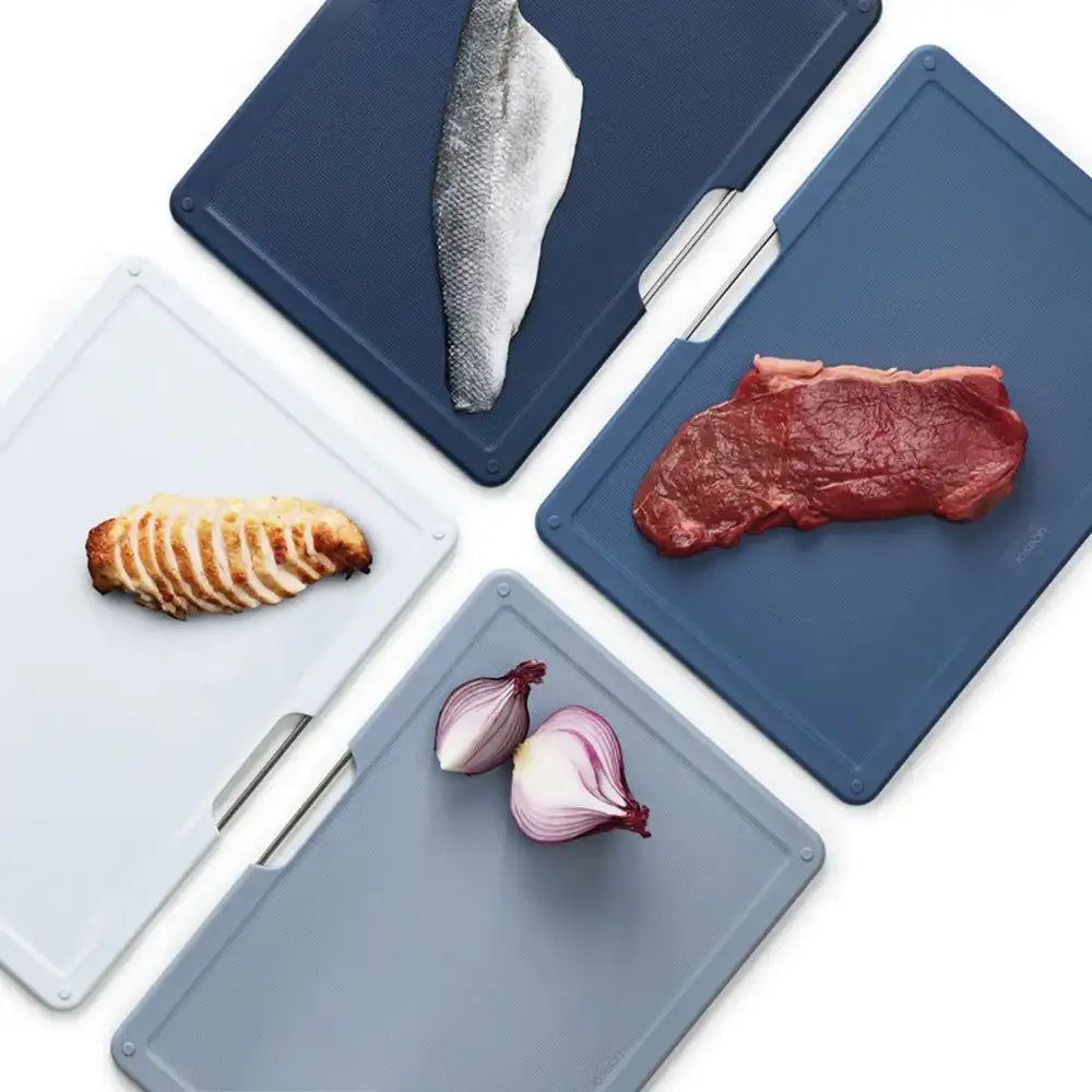 Set of cutting boards with various food items on a white background