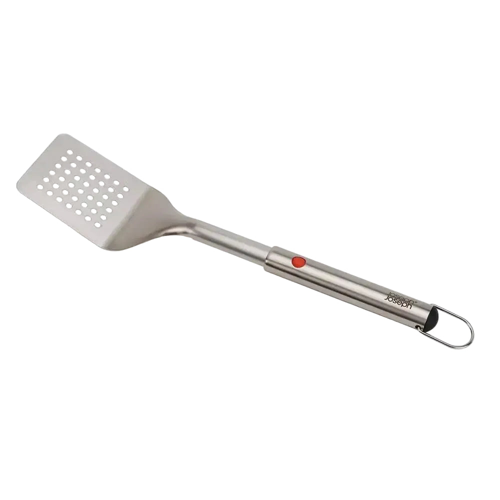 Metal spatula with perforated design on a white background